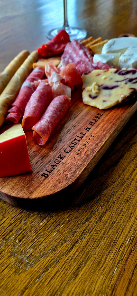 Close-up of Black Castle & Hare Kildare logo on a 15mm thick food-safe acacia wood charcuterie board for 10 people.