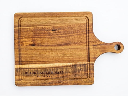 Mini 285mm x 195mm wooden chopping board with juice groove and handle double oiled by Black Castle & Hare Kildare on a white background.