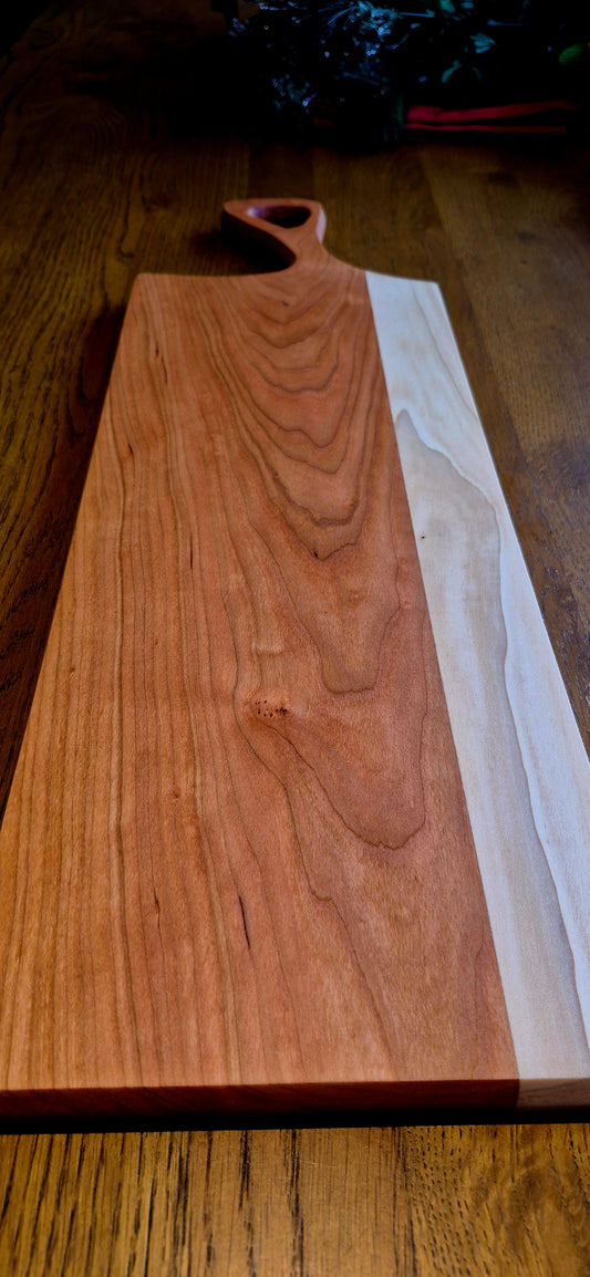 Sleek minimalist handle detail on a 595mm long wooden serving board.