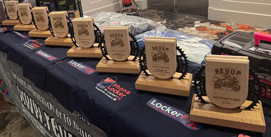 Table with wooden awards and branded cloths in a room setting