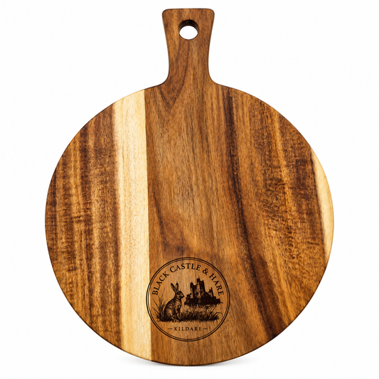A round wooden serving board with a handle and a hanging hole, featuring natural wood grain and a laser-engraved 'Black Castle & Fire' logo at the bottom.