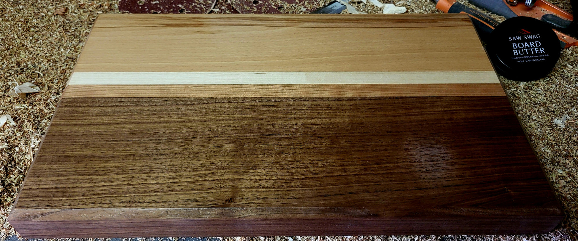 Wooden cutting board with a white stripe on a textured surface With Walnut Beech Cherry and Maple