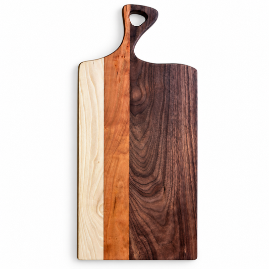 A rectangular wooden serving board with a handle, featuring three vertical wood grain sections: a light natural wood on the left, a medium warm wood in the middle, and a dark brown wood on the right.