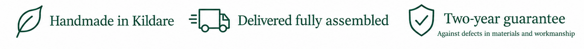 Three marketing feature icons on a light beige background: a leaf with 'Handmade in Kildare', a delivery truck with 'Delivered fully assembled', and a shield with 'Two-year guarantee'.