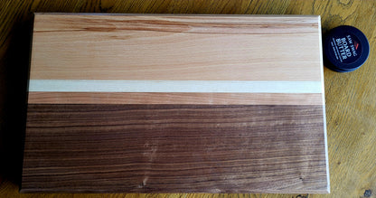 Wooden cutting board with a visible brand logo on a wooden surface