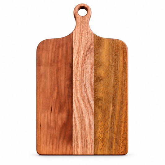 A rectangular wooden cutting board with rounded corners, a built-in handle with a circular hole at the top, and three vertical wood-grain panels in warm brown and reddish tones, shown on a plain white background.