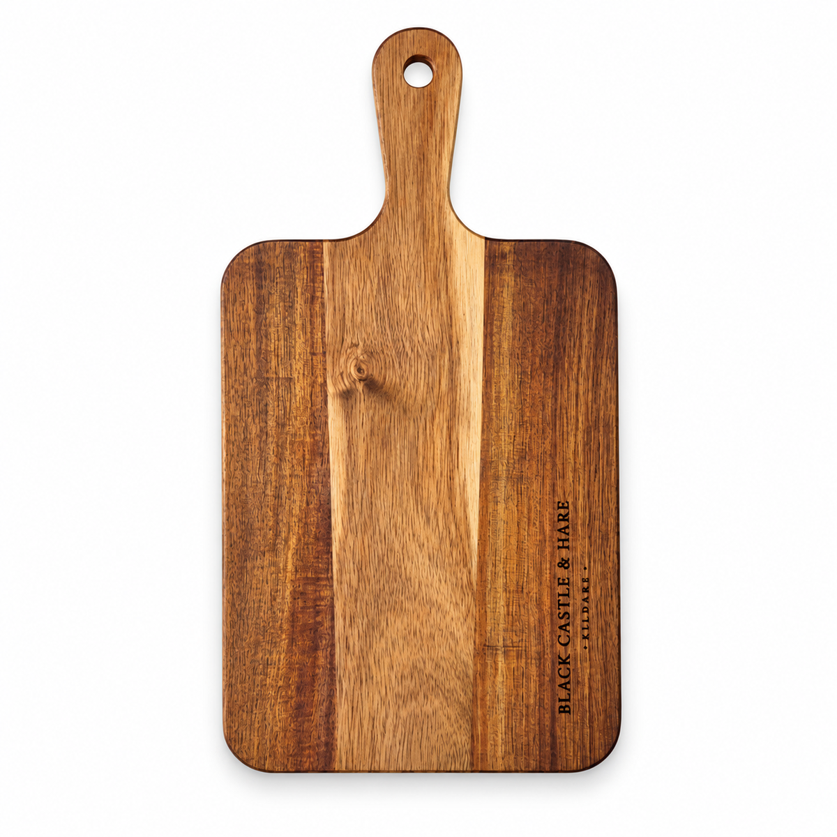 A rectangular wooden cutting board with a rounded handle and a hanging hole, featuring a vertical grain pattern and the engraved brand name 'BLACK CASTLE & HARE LONDON' on the right side, shown against a plain white background.