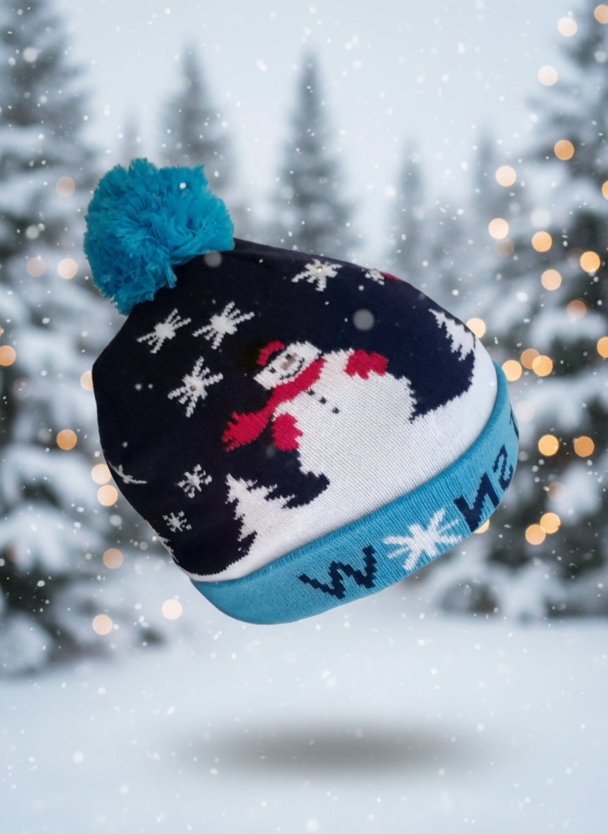 The Anti-Grinch Flashing Christmas Beanie placed on a snowy outdoor surface, showing its snug, one-size fit.