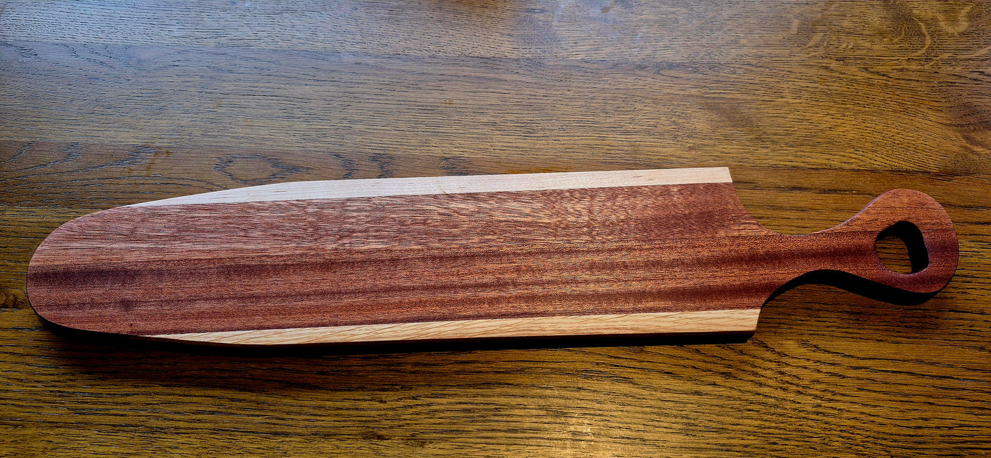 A finished Oak, Poplar, and Sapele Mahogany board in the maker's workshop showing the thickness and handcrafted quality