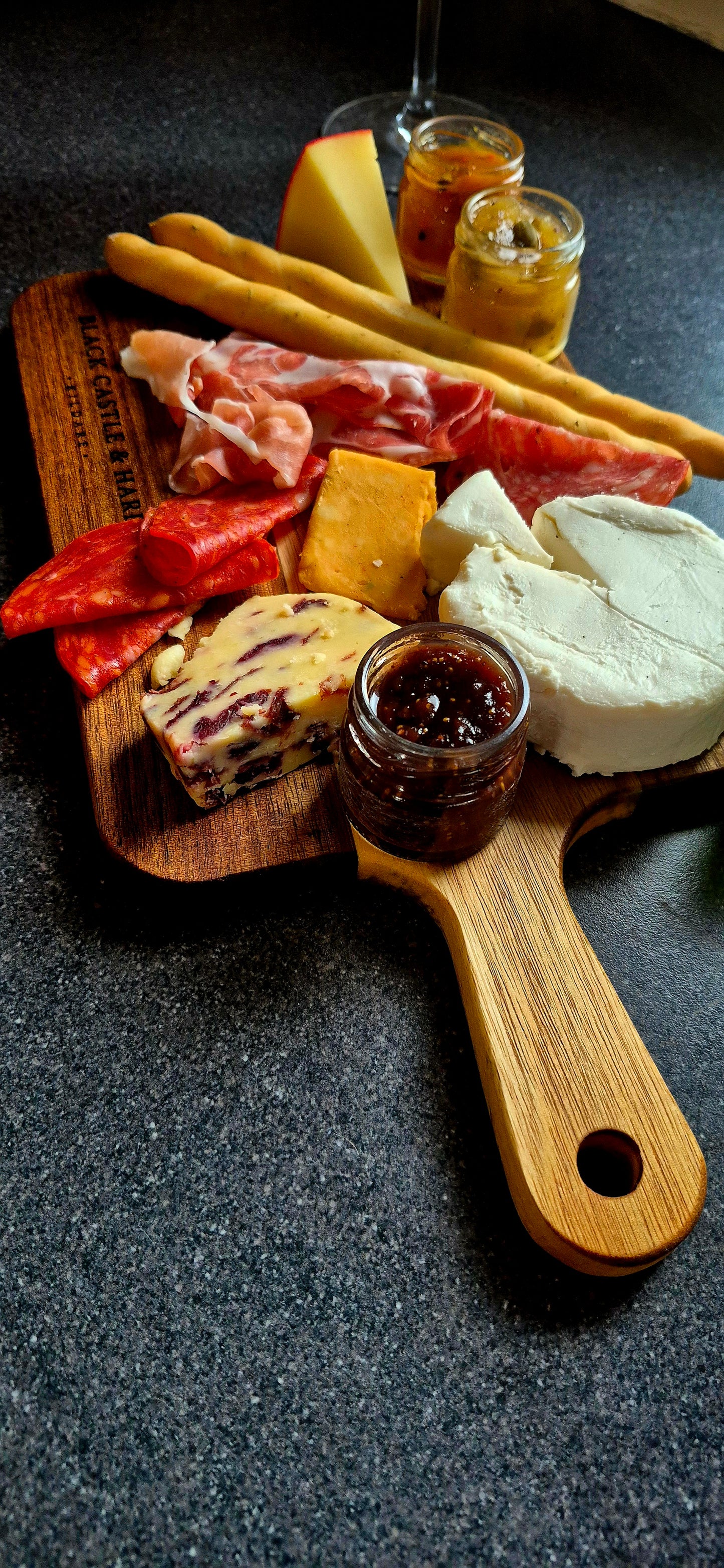 Gourmet meat and cheese selection served near the handle of a food-safe mineral-oiled acacia wooden board by Black Castle & Hare Kildare