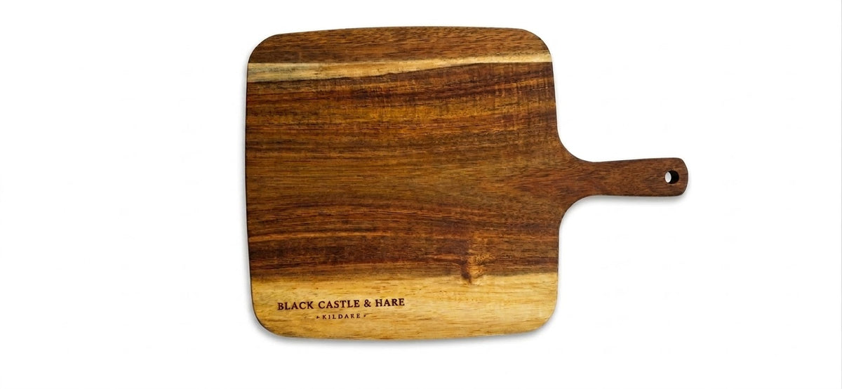 Large 350mm x 250mm acacia charcuterie board double oiled with food-safe mineral oil by Black Castle & Hare Kildare on white background.