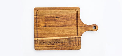 Mini 285mm x 195mm wooden chopping board with juice groove and handle double oiled by Black Castle & Hare Kildare on a white background.