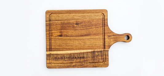Mini 285mm x 195mm wooden chopping board with juice groove and handle double oiled by Black Castle & Hare Kildare on a white background.