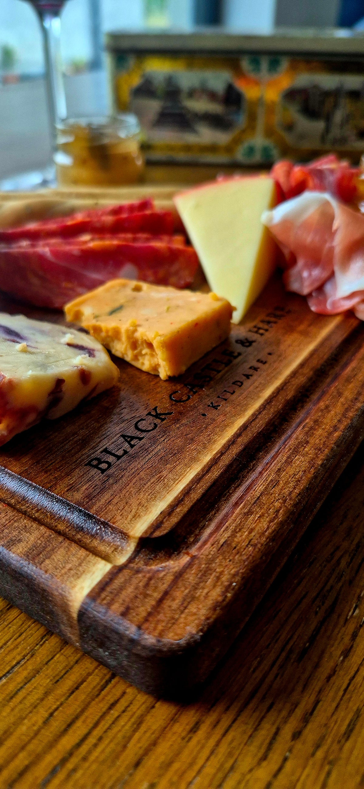 Detailed view of fresh food being sliced on a handcrafted wooden chopping board measuring 285mm by 195mm featuring a protective juice groove