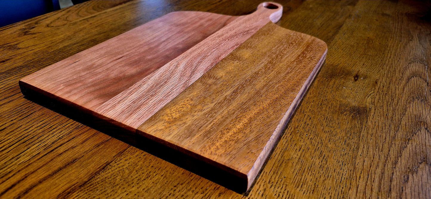 Handcrafted charcuterie board featuring a modern minimal handle, made from Cherry, Oak, and Southern Yellow Pine hardwoods