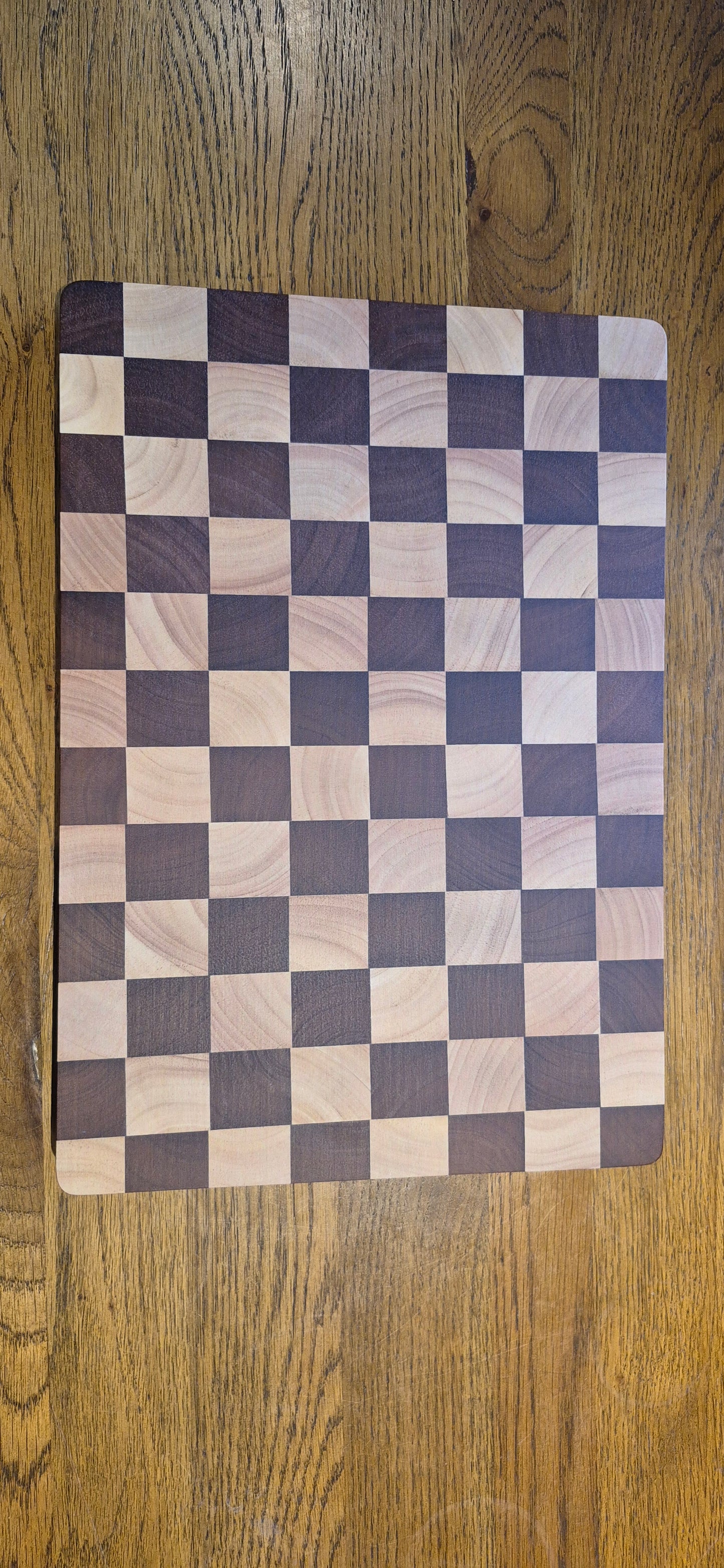 The large Chessboard Rubberwood Chopping Board displayed beautifully on a kitchen countertop.