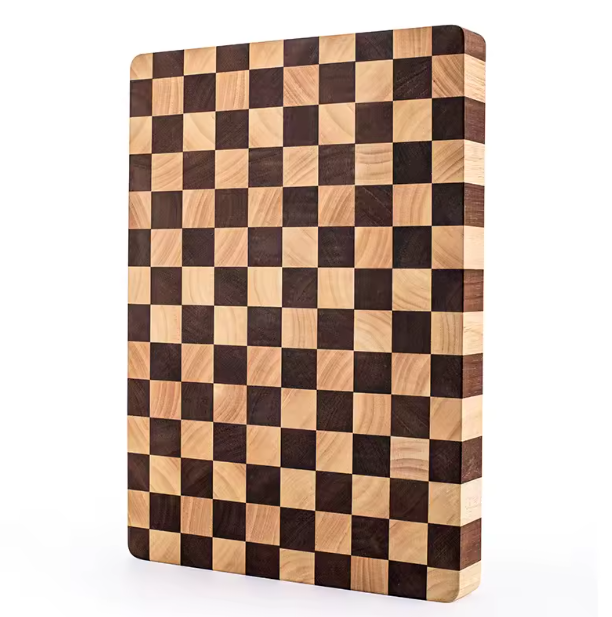 Close-up of a knife resting on the end-grain surface of the Chessboard Rubberwood Cutting Board, highlighting its durability.