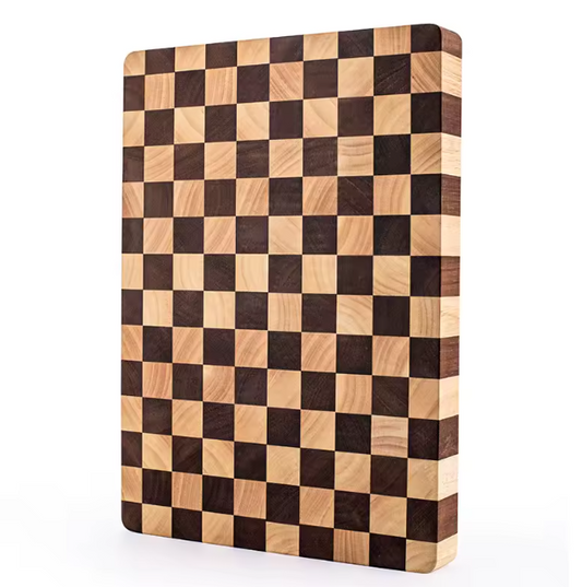 Close-up of a knife resting on the end-grain surface of the Chessboard Rubberwood Cutting Board, highlighting its durability.