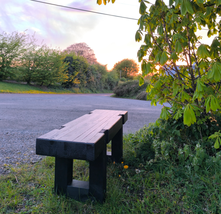 Fully assembled heavy-duty solid wooden bench ready for use in a backyard or frontyard setting