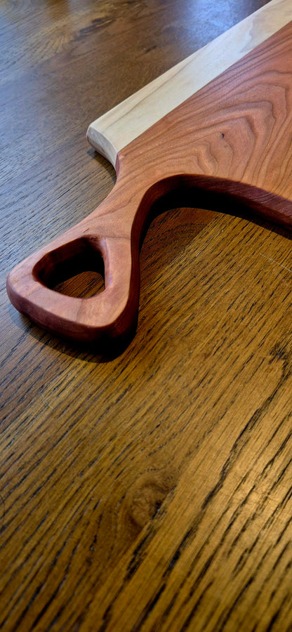 Sleek minimalist handle detail on a 595mm long wooden serving board.