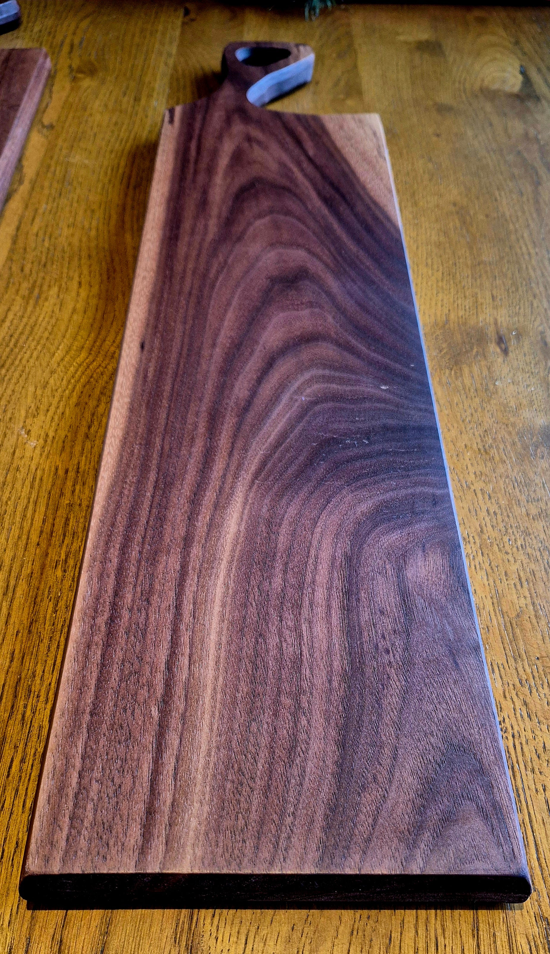 View of the slim 20mm profile of the solid Walnut board, showing its sleek and modern design