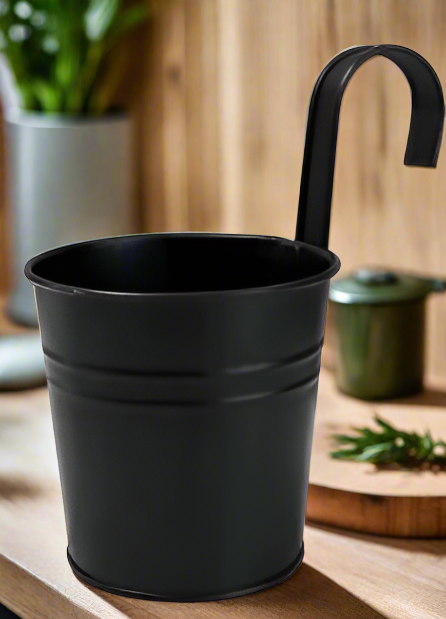 Stylish metal plant pot displayed on indoor shelf