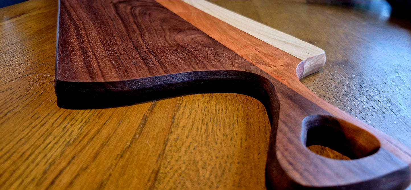 Close-up of the natural color contrast between dark American Walnut, reddish Cherry, and light Poplar wood grain