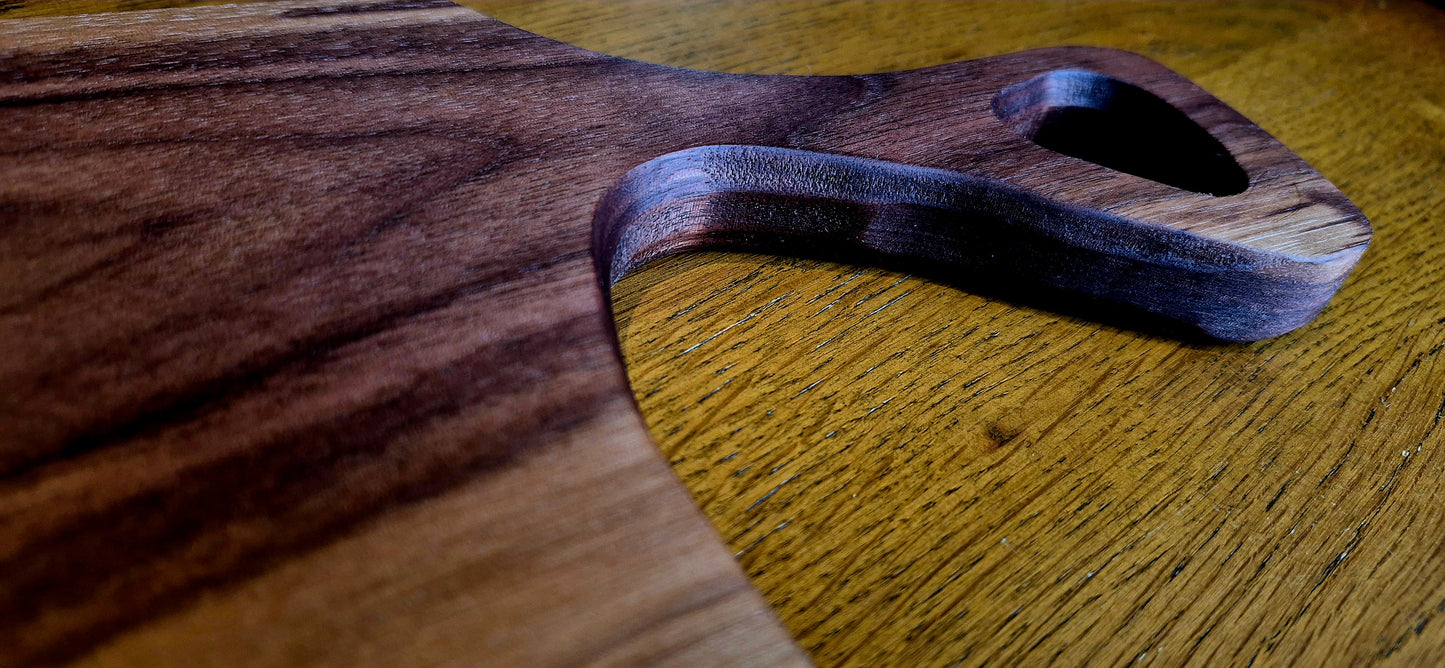 Overhead view of a slim 635×145 mm solid Walnut charcuterie board for long dining tables.
