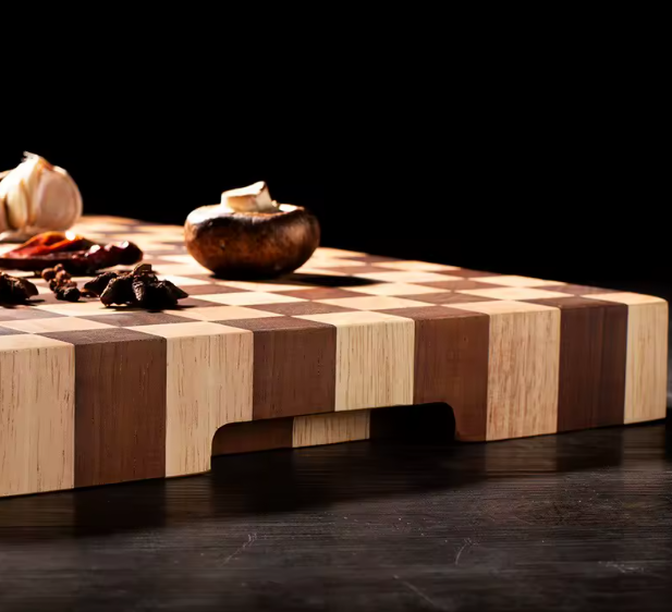 Wooden cutting board with checkered pattern on a dark surface