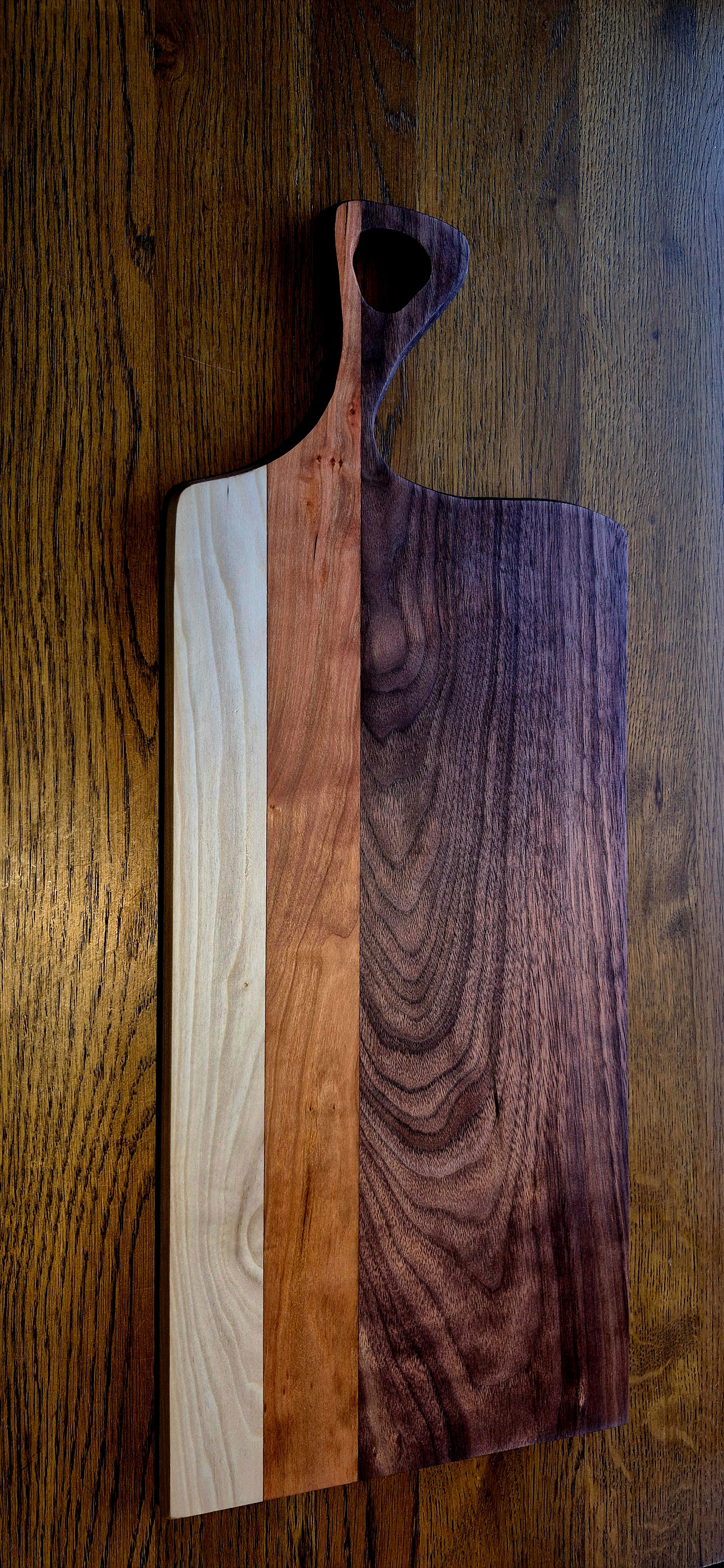 A large handcrafted serving board made from Walnut, Cherry, and Poplar hardwoods with a rich oil finish