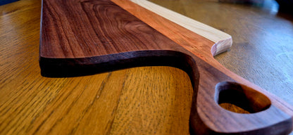 Detailed close-up of the natural grain contrast between Walnut and Cherry wood.
