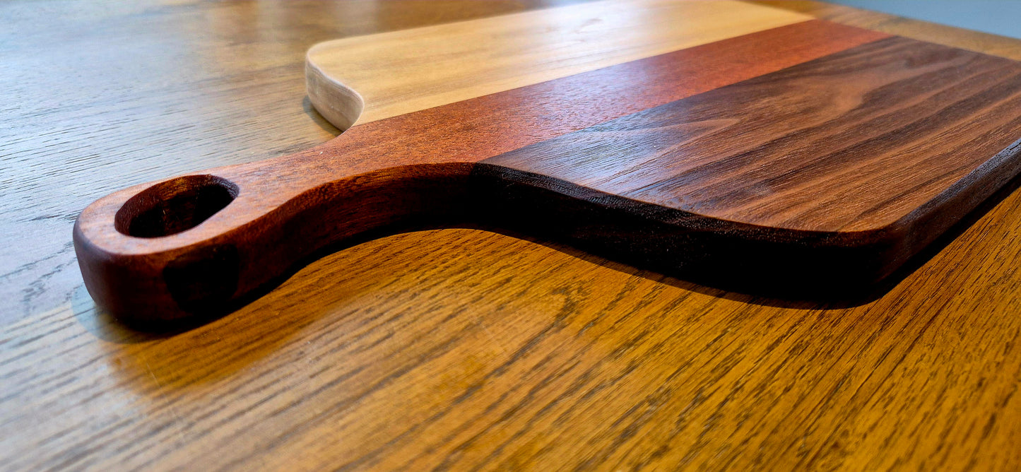 Handcrafted charcuterie board made from Walnut, Sapele Mahogany, and Poplar with a sleek minimal handle